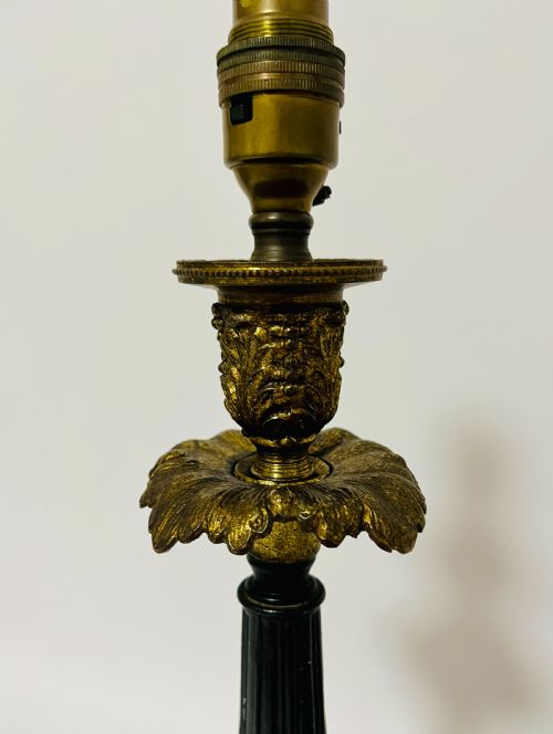 fig 1. An antique French Empire table lamp featuring a gilt bronze fluted column with acanthus leaf details set upon a triangular black marble base.