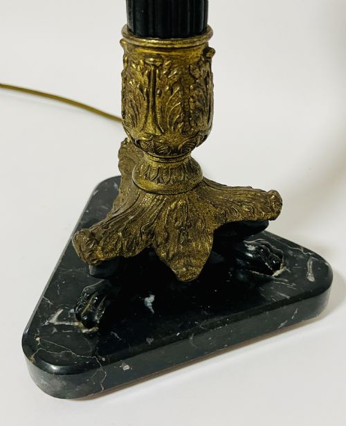 fig 2. An antique French Empire table lamp featuring a gilt bronze fluted column with acanthus leaf details set upon a triangular black marble base.