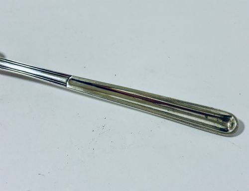 fig 2. An elongated Georgian silver marrow scoop featuring a deep concave channel end tapering along a linear stem.
