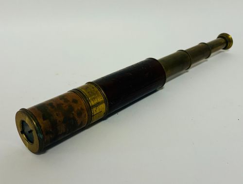 fig 1. An extended three-draw antique brass pocket telescope featuring a dark brown textured leather barrel wrap.