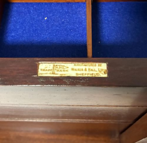 fig 2. An Edwardian warm brown mahogany collectors box featuring wood inlay, brass drop handles, and a polished lid.