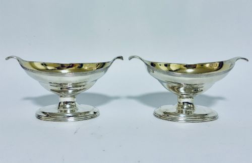 fig 1. A pair of Georgian sterling silver boat-shaped salt cellars with pedestal bases and gilded interiors.