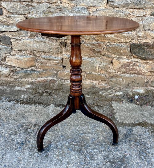 fig 1. An antique Regency mahogany wine table featuring a circular top, turned pedestal stem, and three cabriole tripod legs.