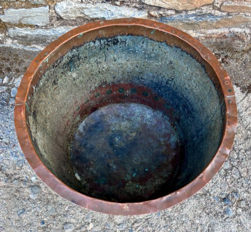 fig 1. A large round copper boiler with a hand-riveted base seam and flared rim, supported on four decorative cast brass claw feet.