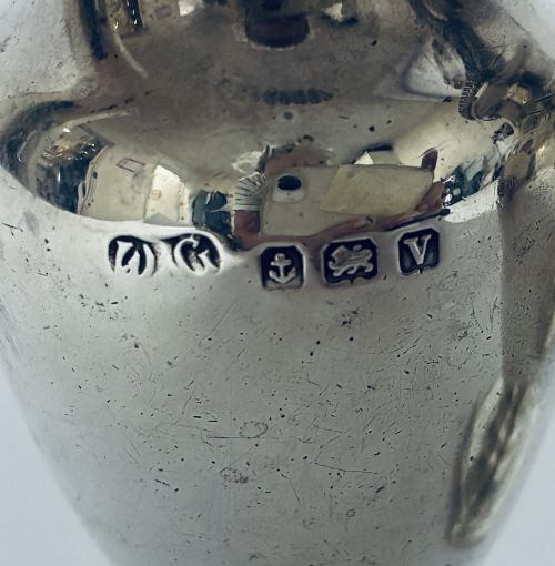 fig 2. A pair of hallmarked sterling silver baluster pepper pots featuring pierced domed lids with finials and octagonal pedestal bases.