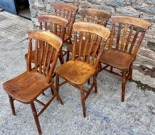 fig 2. A set of six Victorian country dining chairs featuring curved top rails, vertical lathe back slats, shaped solid elm seats, and turned legs.