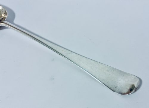 fig 2. An 18th-century silver serving spoon featuring an elongated oval bowl and a smooth tapered handle.