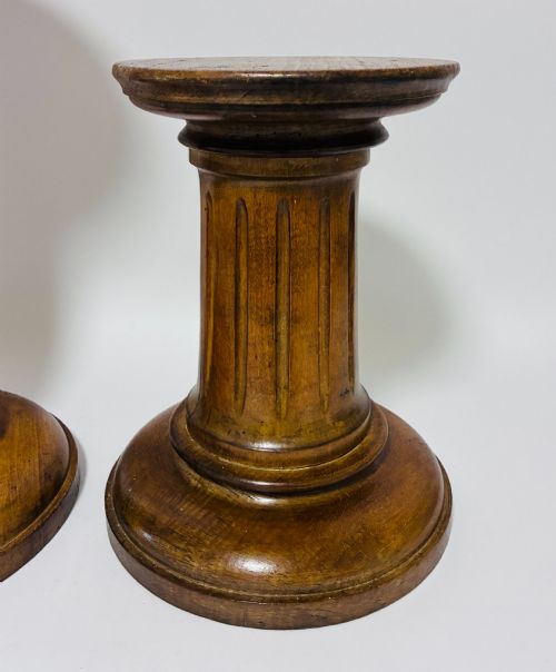 fig 1. A pair of turned oak Neoclassical display pedestals featuring fluted columns and circular molded tops.
