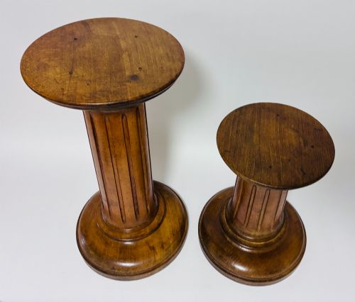 fig 2. A pair of turned oak Neoclassical display pedestals featuring fluted columns and circular molded tops.