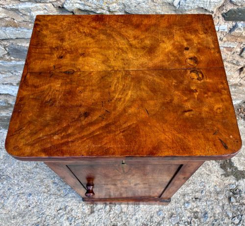 fig 1. An antique French walnut pot cupboard with a figured burr walnut door panel, frieze drawer, and plinth base.