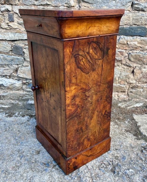 fig 2. An antique French walnut pot cupboard with a figured burr walnut door panel, frieze drawer, and plinth base.