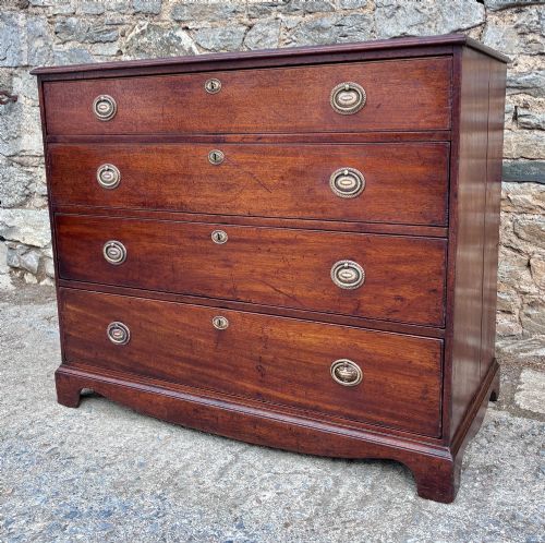 fig 2. A Georgian mahogany chest of drawers featuring four graduated drawers with circular brass ring pull handles and bracket feet.