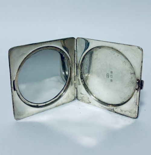 fig 2. A square Art Deco silver powder compact with an engine-turned guilloche surface and a stepped geometric motif.