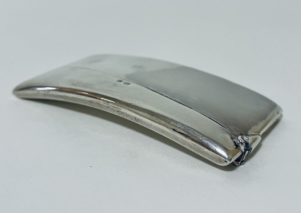 A polished sterling silver rectangular calling card case featuring a gentle curve and visible British hallmarks near the upper rim. View XIII