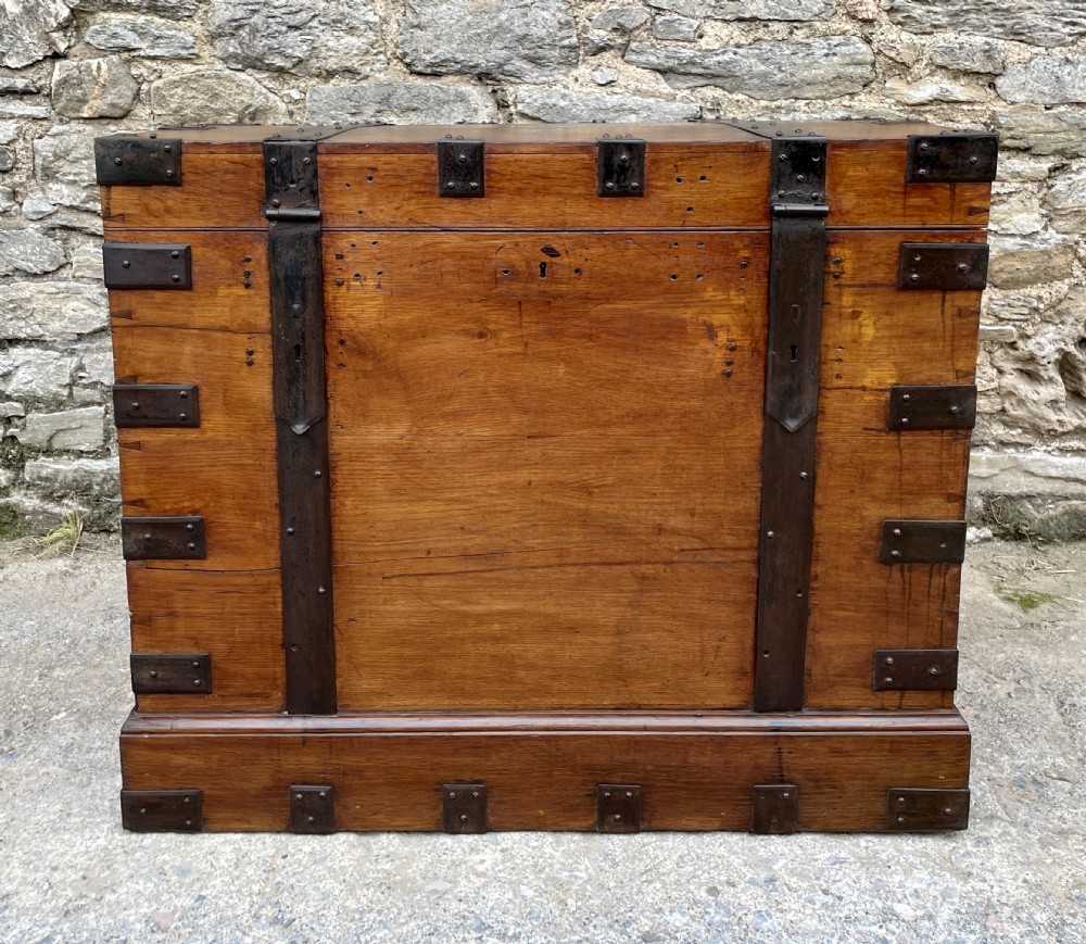 A large Victorian warm brown oak silver chest featuring dark iron straps, corner brackets, and a central keyhole. View II