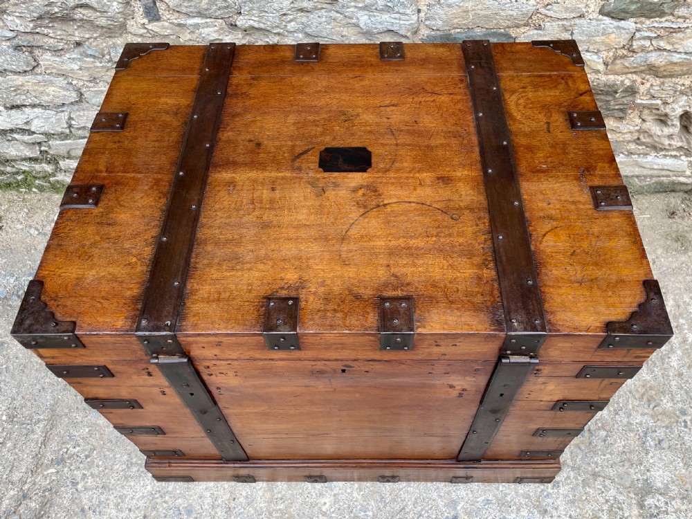 A large Victorian warm brown oak silver chest featuring dark iron straps, corner brackets, and a central keyhole. View X