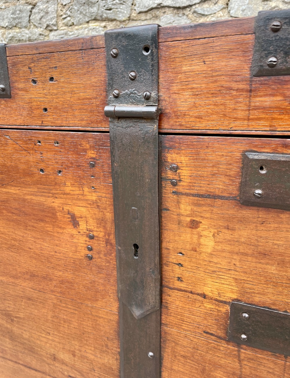 A large Victorian warm brown oak silver chest featuring dark iron straps, corner brackets, and a central keyhole. View XI