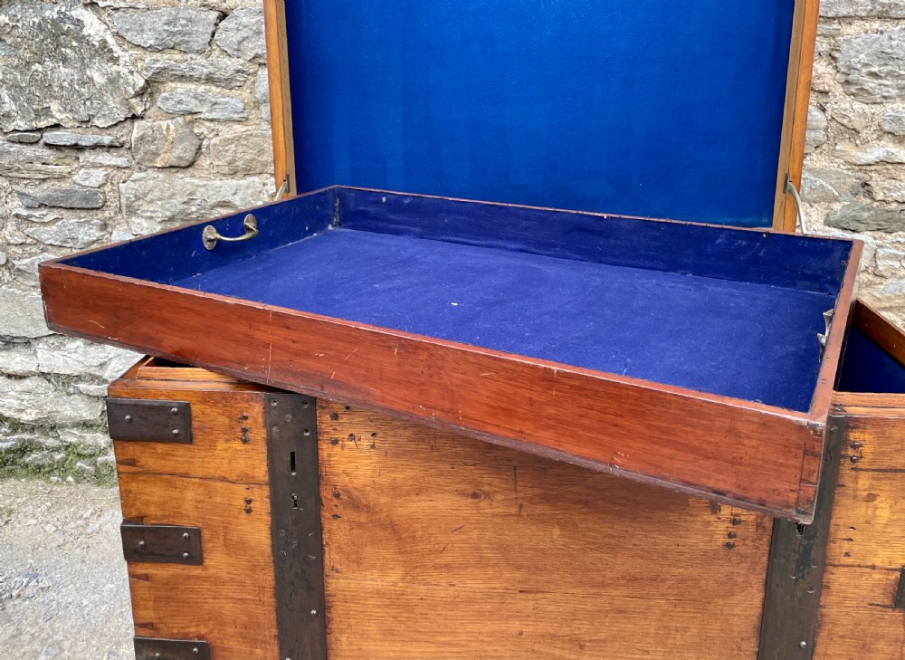 A large Victorian warm brown oak silver chest featuring dark iron straps, corner brackets, and a central keyhole. View XII