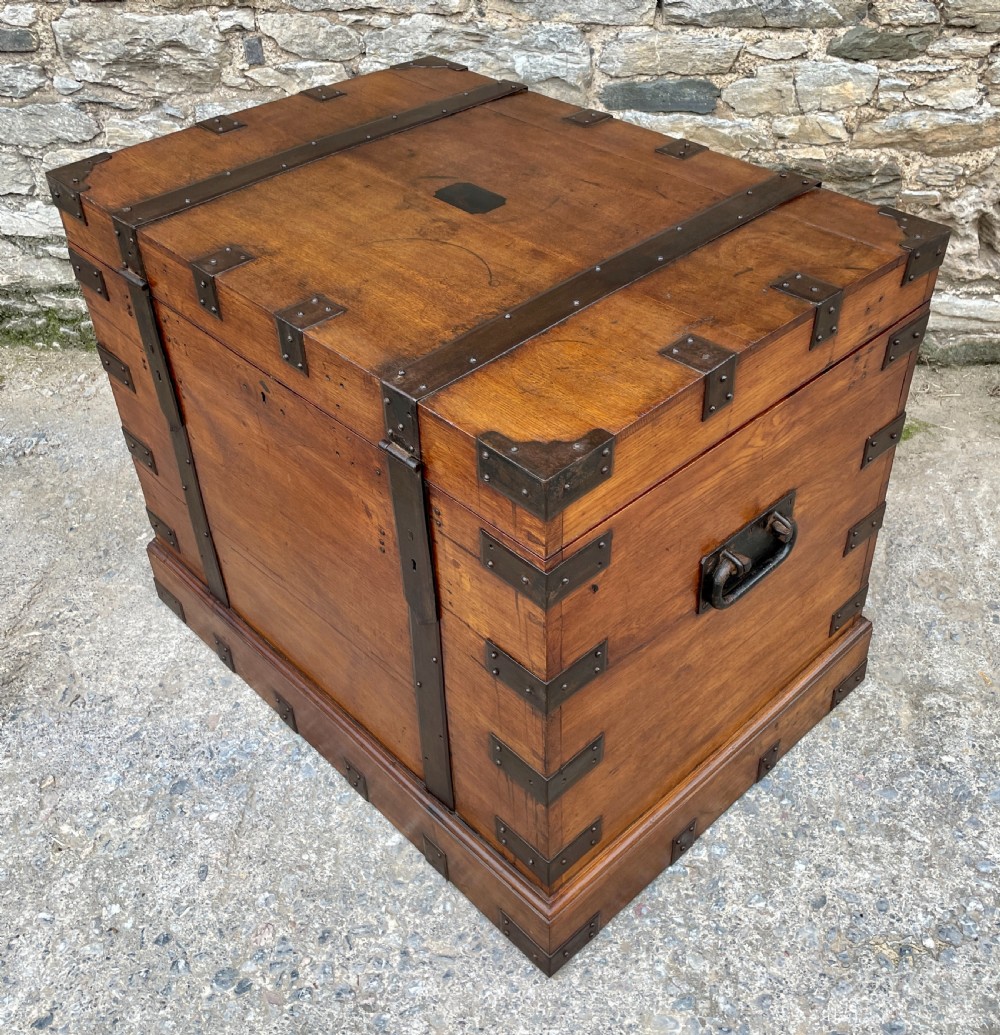 A large Victorian warm brown oak silver chest featuring dark iron straps, corner brackets, and a central keyhole. View XVIII