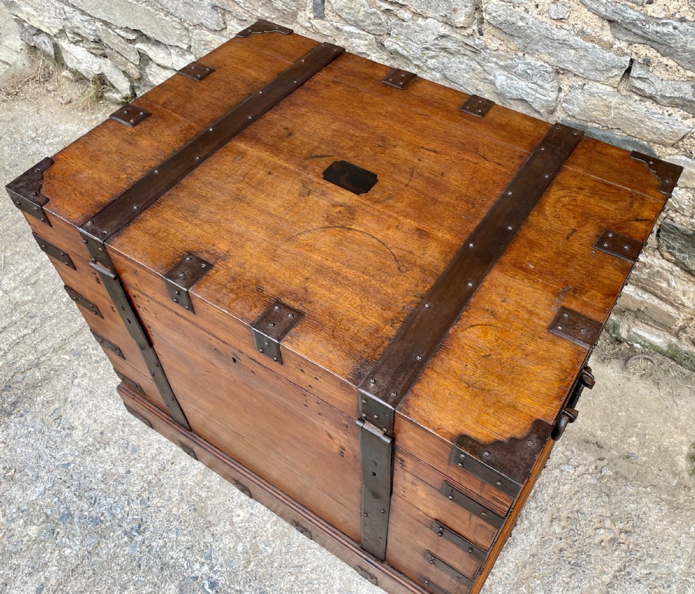 A large Victorian warm brown oak silver chest featuring dark iron straps, corner brackets, and a central keyhole. View XX