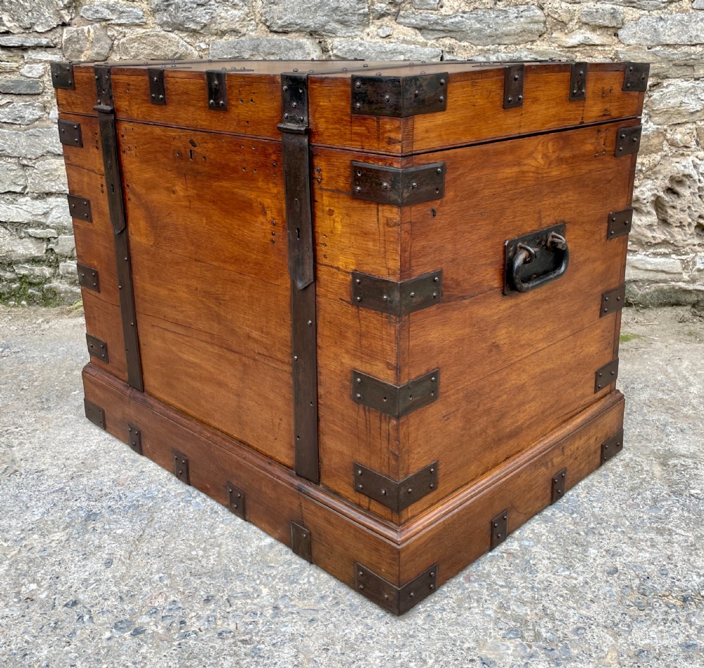 A large Victorian warm brown oak silver chest featuring dark iron straps, corner brackets, and a central keyhole. View XXV