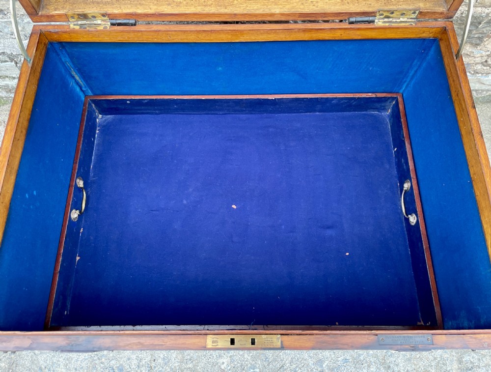 A large Victorian warm brown oak silver chest featuring dark iron straps, corner brackets, and a central keyhole. View XXVIII