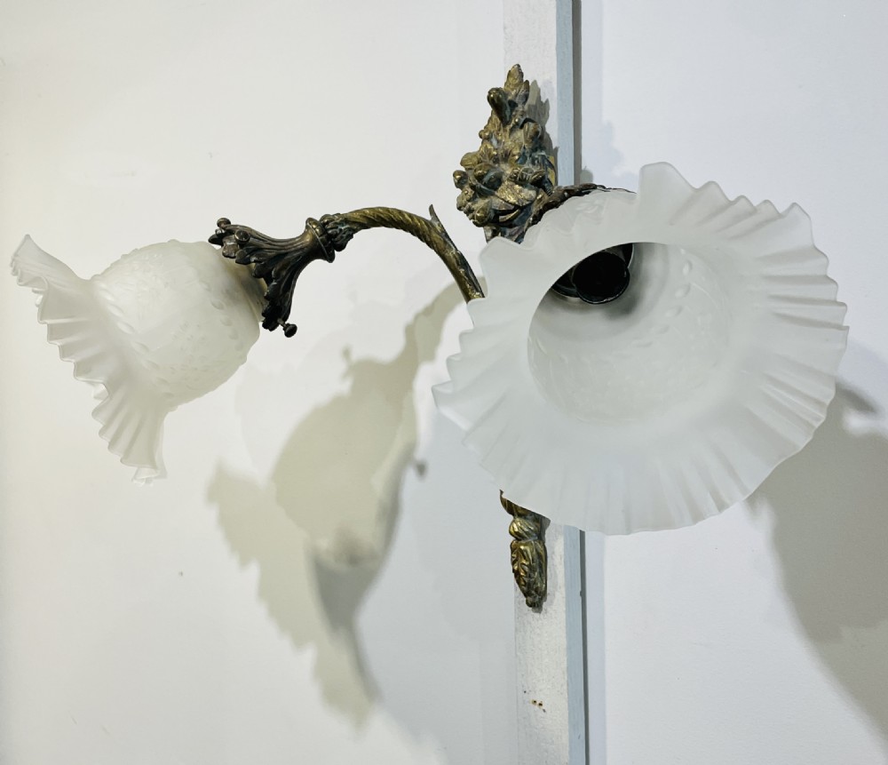 A Victorian twin-arm gilt brass wall sconce featuring reeded details, acanthus leaf motifs, and frosted frilled glass shades with etched floral patterns. View III