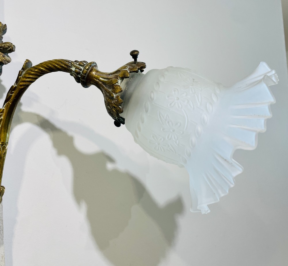 A Victorian twin-arm gilt brass wall sconce featuring reeded details, acanthus leaf motifs, and frosted frilled glass shades with etched floral patterns. View VIII