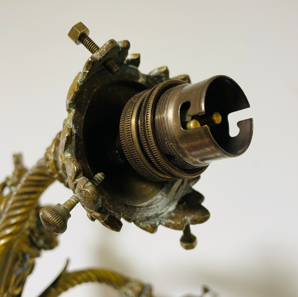 A Victorian twin-arm gilt brass wall sconce featuring reeded details, acanthus leaf motifs, and frosted frilled glass shades with etched floral patterns. View XIV