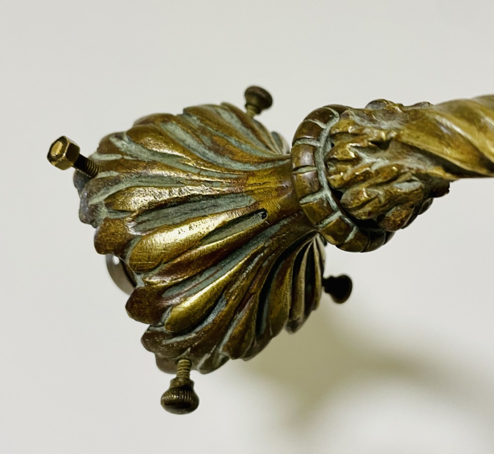 A Victorian twin-arm gilt brass wall sconce featuring reeded details, acanthus leaf motifs, and frosted frilled glass shades with etched floral patterns. View XVIII