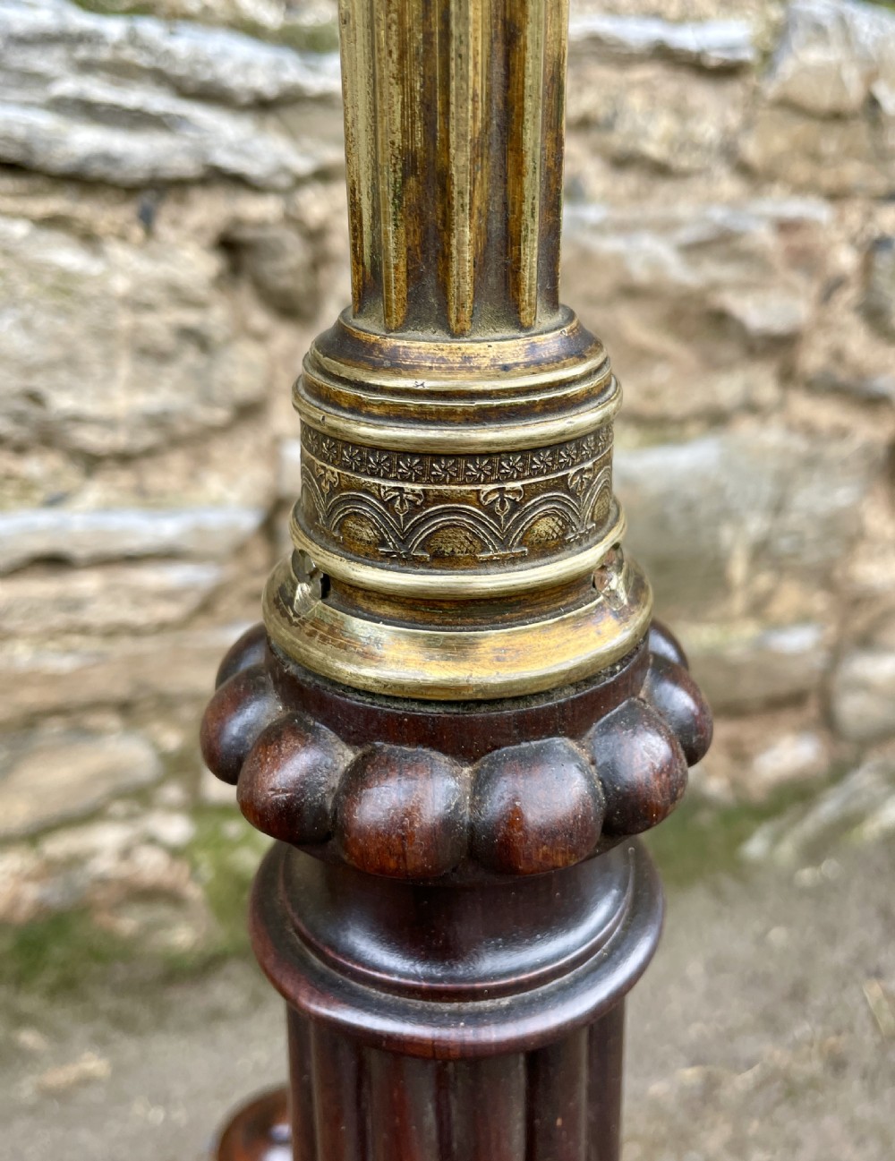 A Regency rosewood pole screen featuring a carved tripod base, adjustable brass rod, and a framed needlepoint panel with a floral wreath. View V
