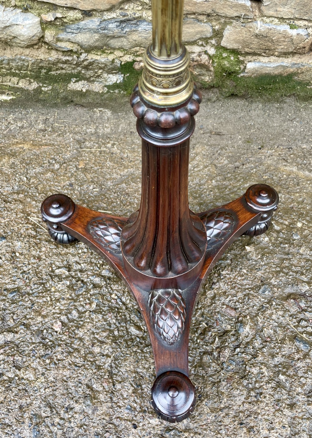 A Regency rosewood pole screen featuring a carved tripod base, adjustable brass rod, and a framed needlepoint panel with a floral wreath. View VI