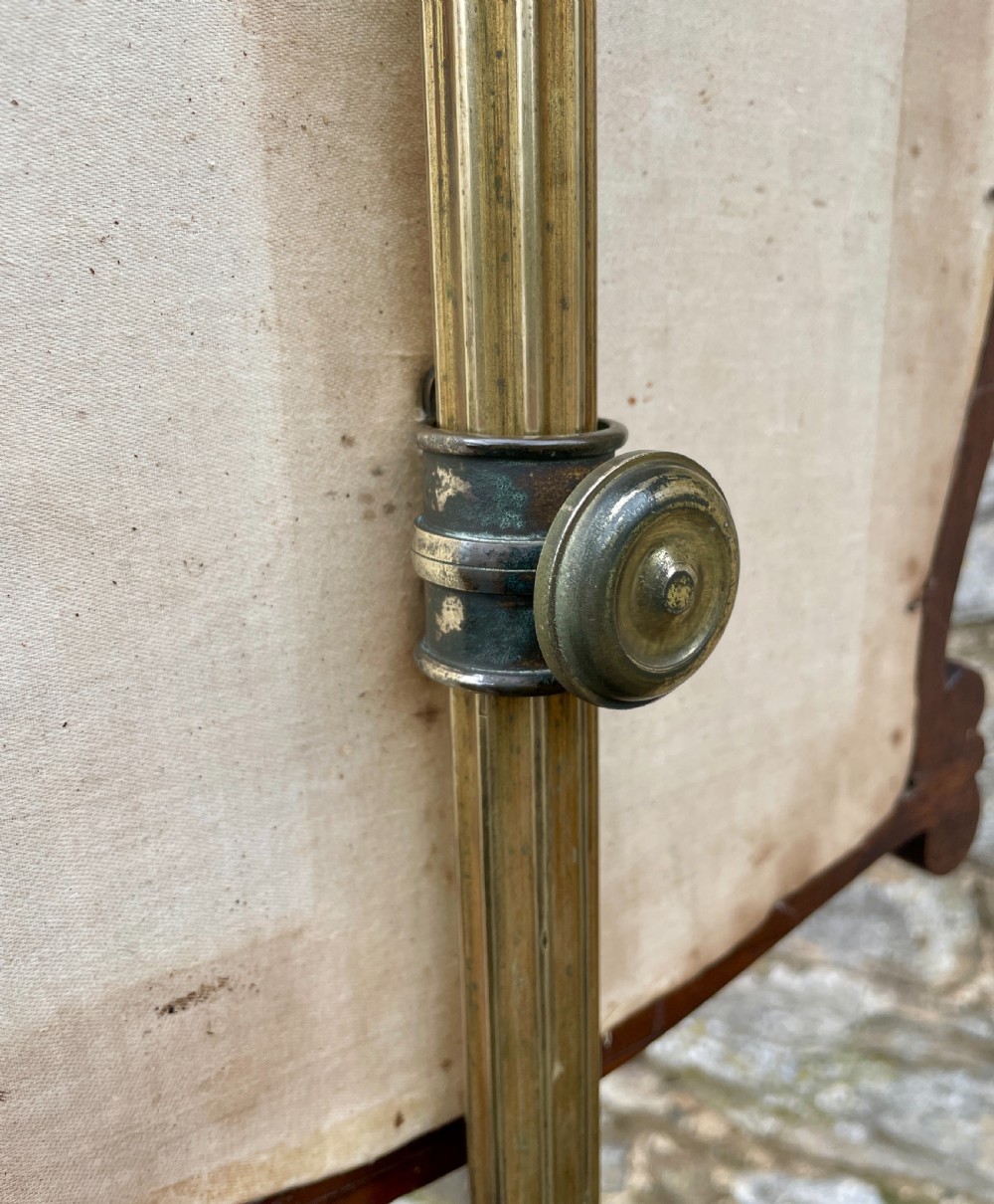 A Regency rosewood pole screen featuring a carved tripod base, adjustable brass rod, and a framed needlepoint panel with a floral wreath. View VII