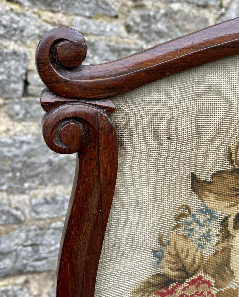A Regency rosewood pole screen featuring a carved tripod base, adjustable brass rod, and a framed needlepoint panel with a floral wreath. View VIII