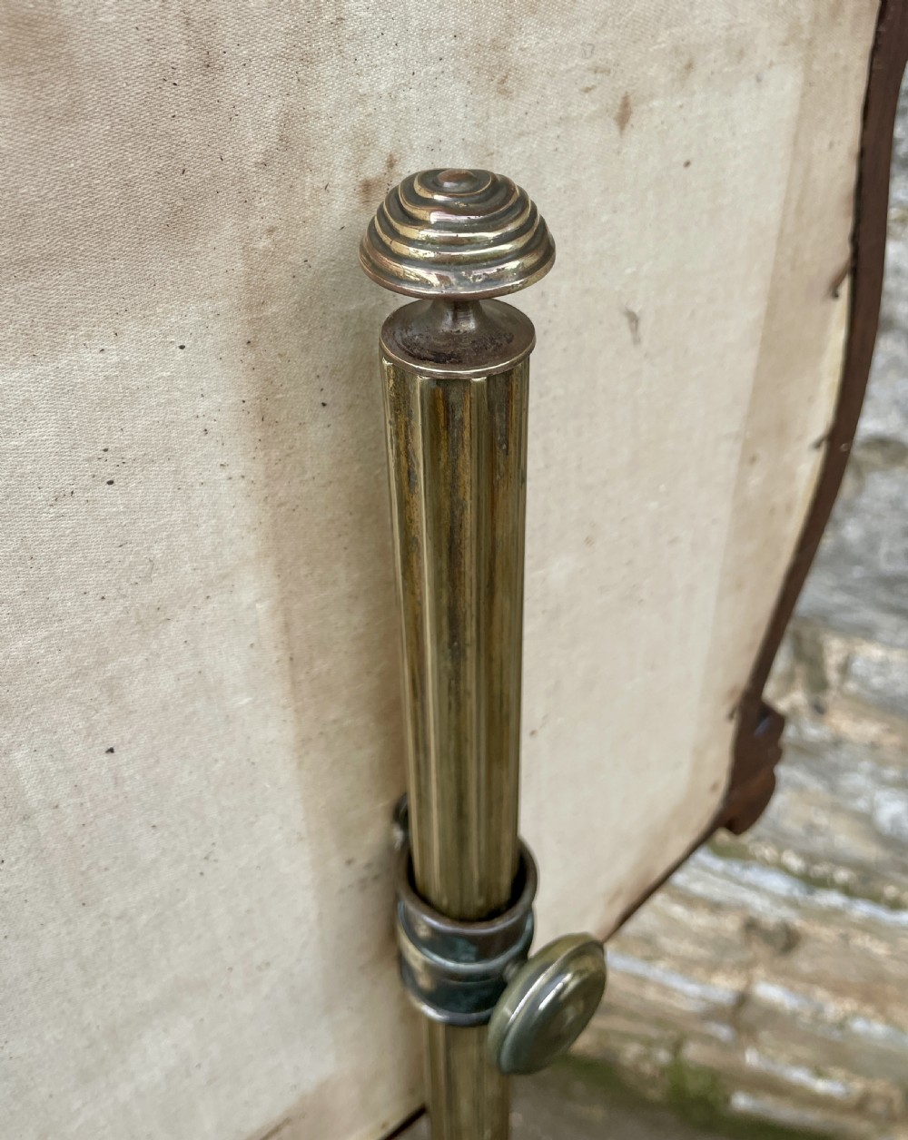 A Regency rosewood pole screen featuring a carved tripod base, adjustable brass rod, and a framed needlepoint panel with a floral wreath. View XI