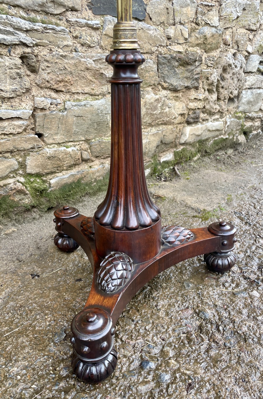 A Regency rosewood pole screen featuring a carved tripod base, adjustable brass rod, and a framed needlepoint panel with a floral wreath. View XV