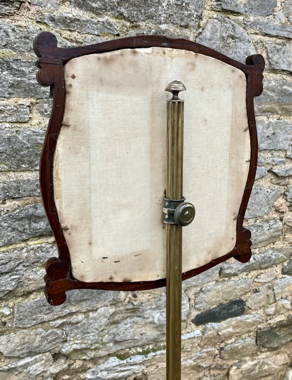 A Regency rosewood pole screen featuring a carved tripod base, adjustable brass rod, and a framed needlepoint panel with a floral wreath. View XVI
