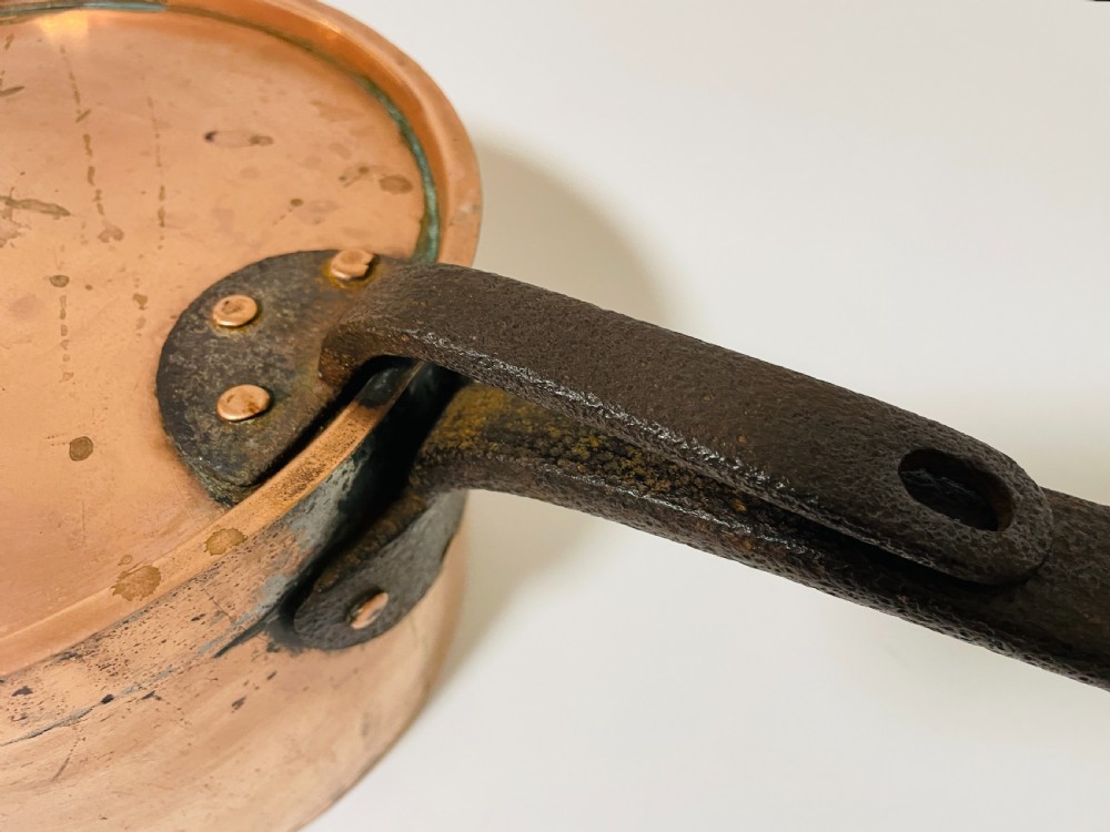 A large Victorian copper saucepan with a flat copper lid and a long dark cast iron handle. View III