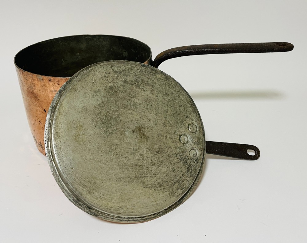 A large Victorian copper saucepan with a flat copper lid and a long dark cast iron handle. View IV