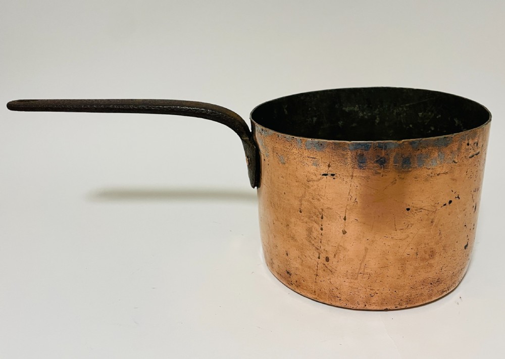 A large Victorian copper saucepan with a flat copper lid and a long dark cast iron handle. View VI