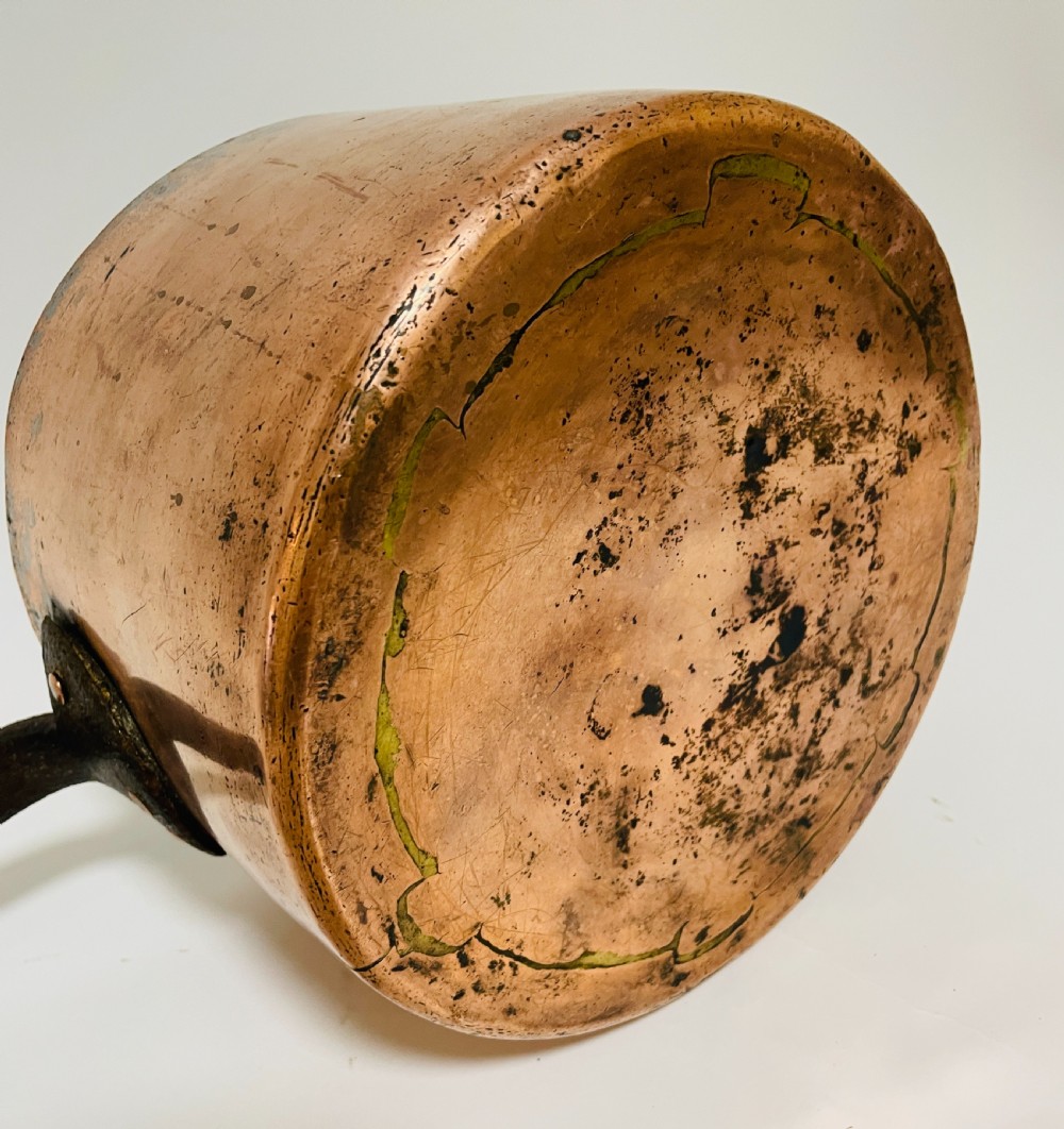 A large Victorian copper saucepan with a flat copper lid and a long dark cast iron handle. View VIII