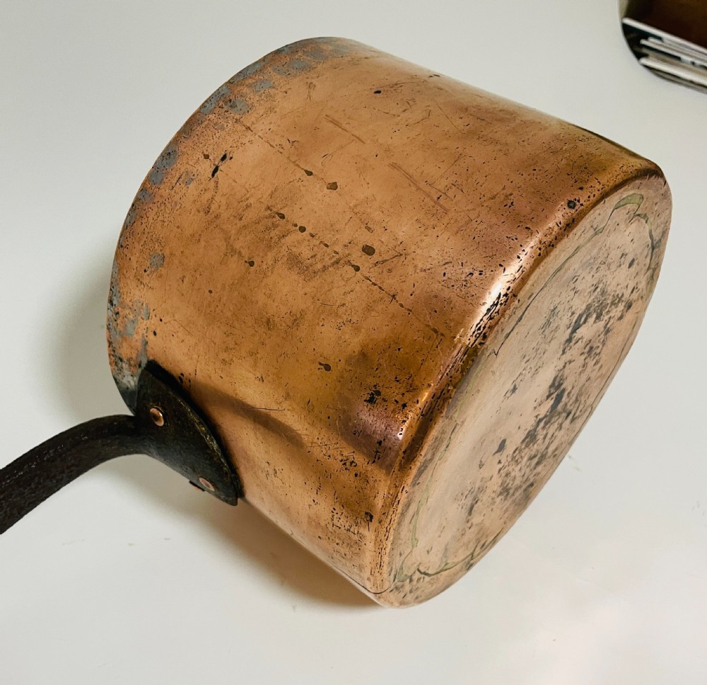 A large Victorian copper saucepan with a flat copper lid and a long dark cast iron handle. View XI