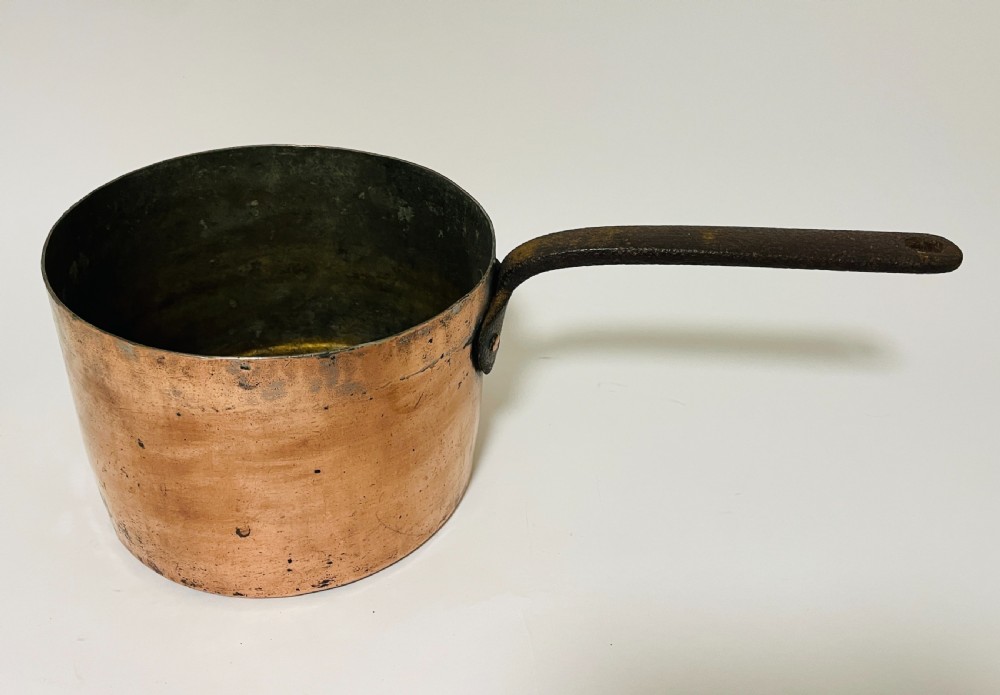 A large Victorian copper saucepan with a flat copper lid and a long dark cast iron handle. View XII