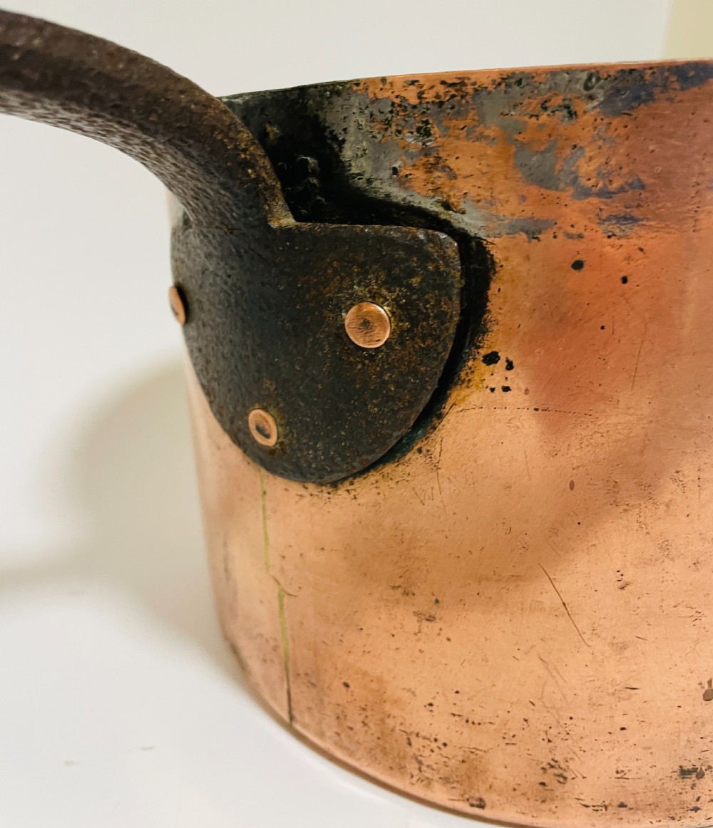 A large Victorian copper saucepan with a flat copper lid and a long dark cast iron handle. View XV