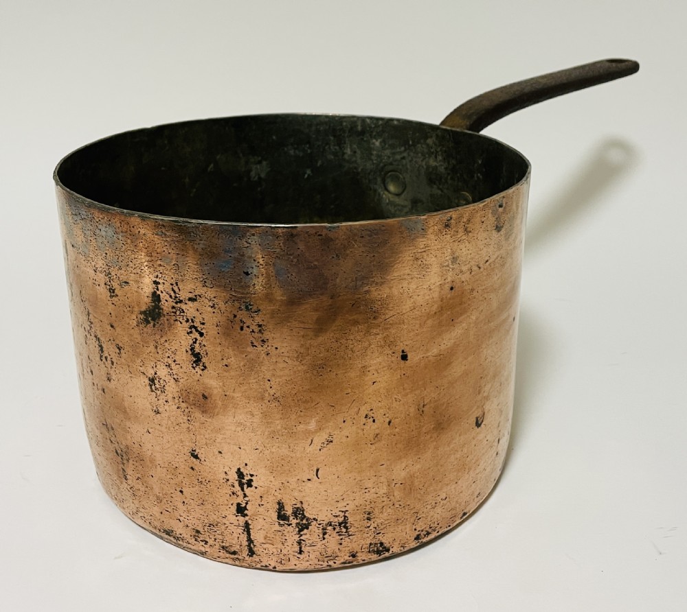 A large Victorian copper saucepan with a flat copper lid and a long dark cast iron handle. View XVI