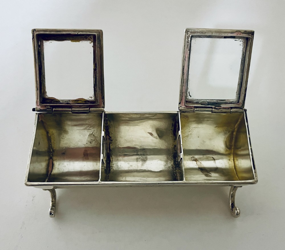 A rectangular Victorian silver double stamp trough with an engraved monogram, raised on four scrolled legs with two glass-topped compartments. View XIII