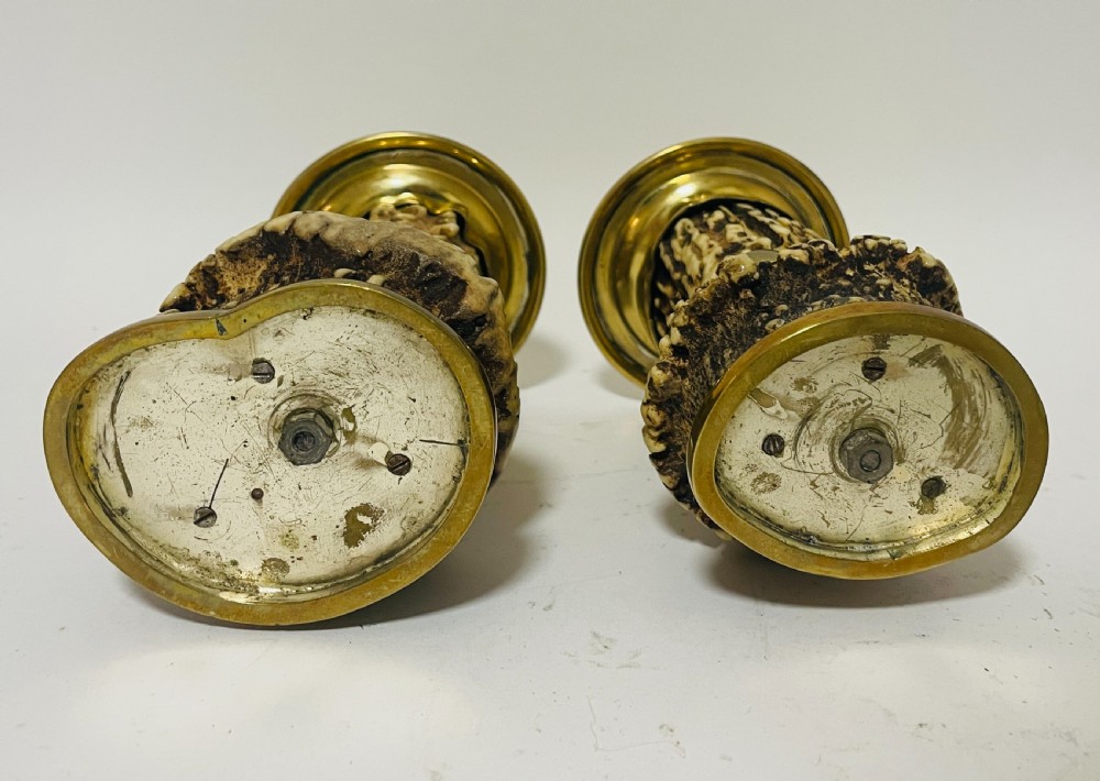 A Victorian desk set featuring a cut-glass inkwell in a brass frame, a brass letter opener with an antler handle, two small antler candlesticks, and a central brass-handled antler object. View VIII