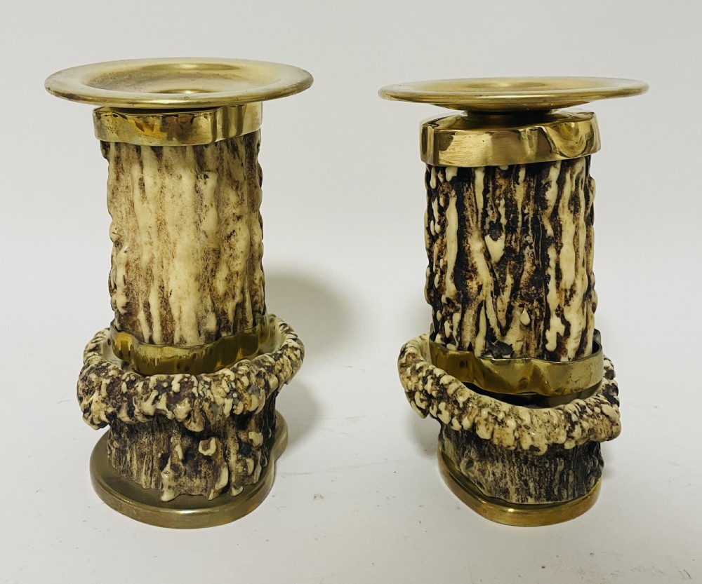 A Victorian desk set featuring a cut-glass inkwell in a brass frame, a brass letter opener with an antler handle, two small antler candlesticks, and a central brass-handled antler object. View XVI