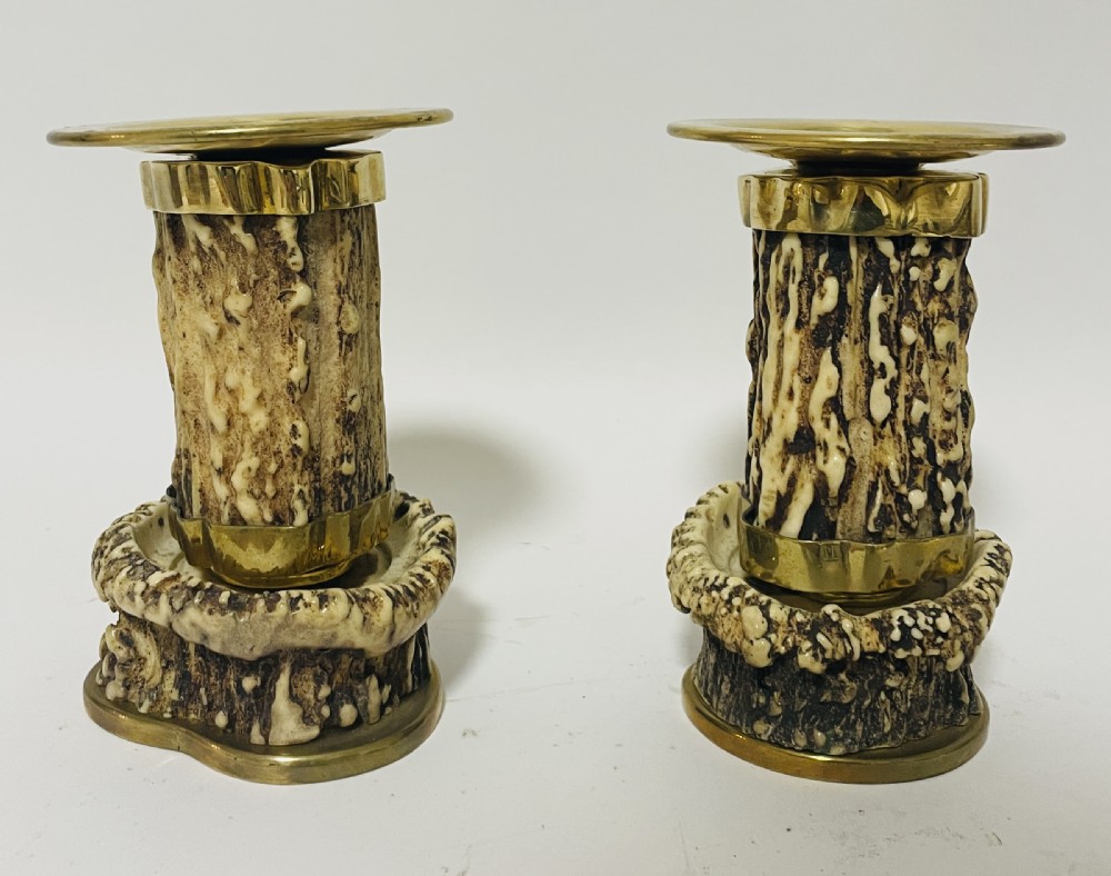 A Victorian desk set featuring a cut-glass inkwell in a brass frame, a brass letter opener with an antler handle, two small antler candlesticks, and a central brass-handled antler object. View XVII