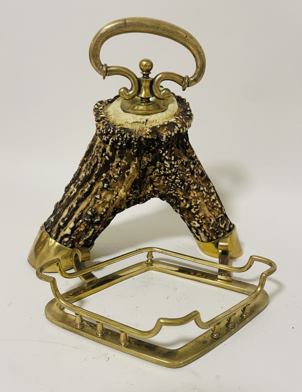 A Victorian desk set featuring a cut-glass inkwell in a brass frame, a brass letter opener with an antler handle, two small antler candlesticks, and a central brass-handled antler object. View XIX
